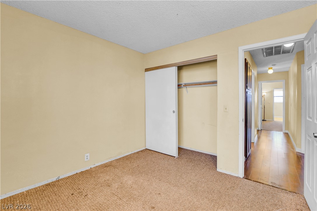 6440 Hartwood Road Las Vegas, NV 89108 - Photo 50 of 59 A well-proportioned bedroom awaits with soft carpet flooring and a convenient sliding closet door.