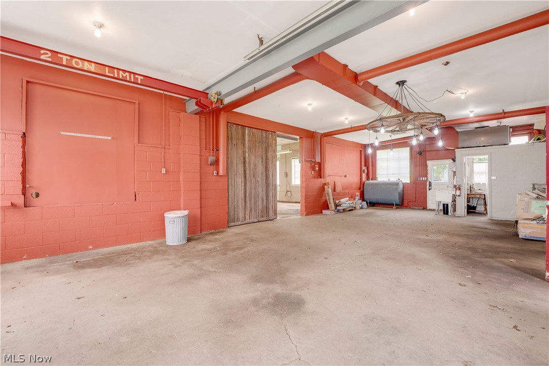 16107 Moseley Road Madison, OH 44057 - Photo 29 of 40 Spacious interior with concrete flooring and exposed structural beams
