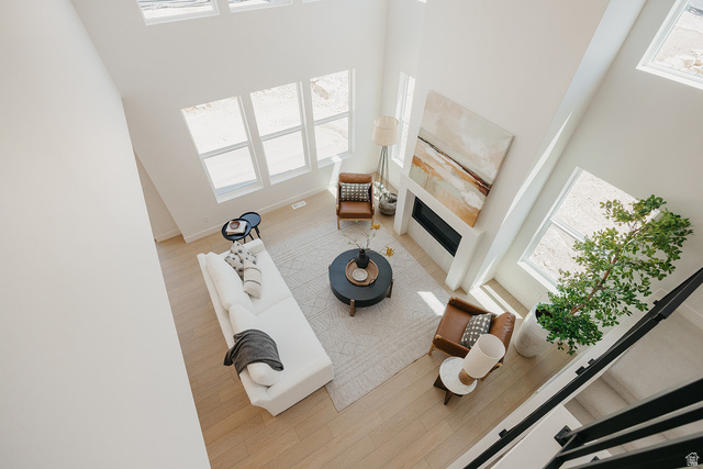 5902 Canyon Rim Road, Unit 620 Lehi, UT 84048 - Photo 26 of 78 Two-story living area featuring a built-in fireplace with white surround, light wood-finish flooring, and multiple large windows