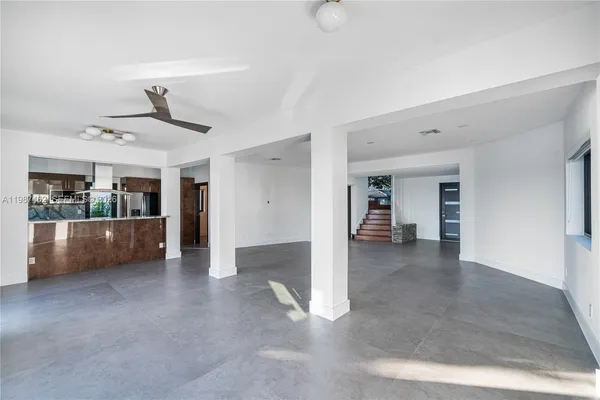 a kitchen with stainless steel appliances kitchen island granite countertop a sink and cabinets