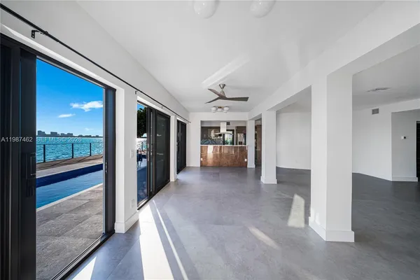 a kitchen with stainless steel appliances kitchen island granite countertop a refrigerator and a stove