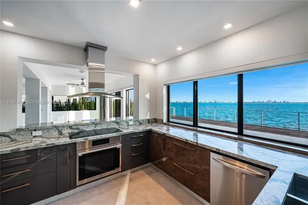 a kitchen with stainless steel appliances granite countertop a sink and stove
