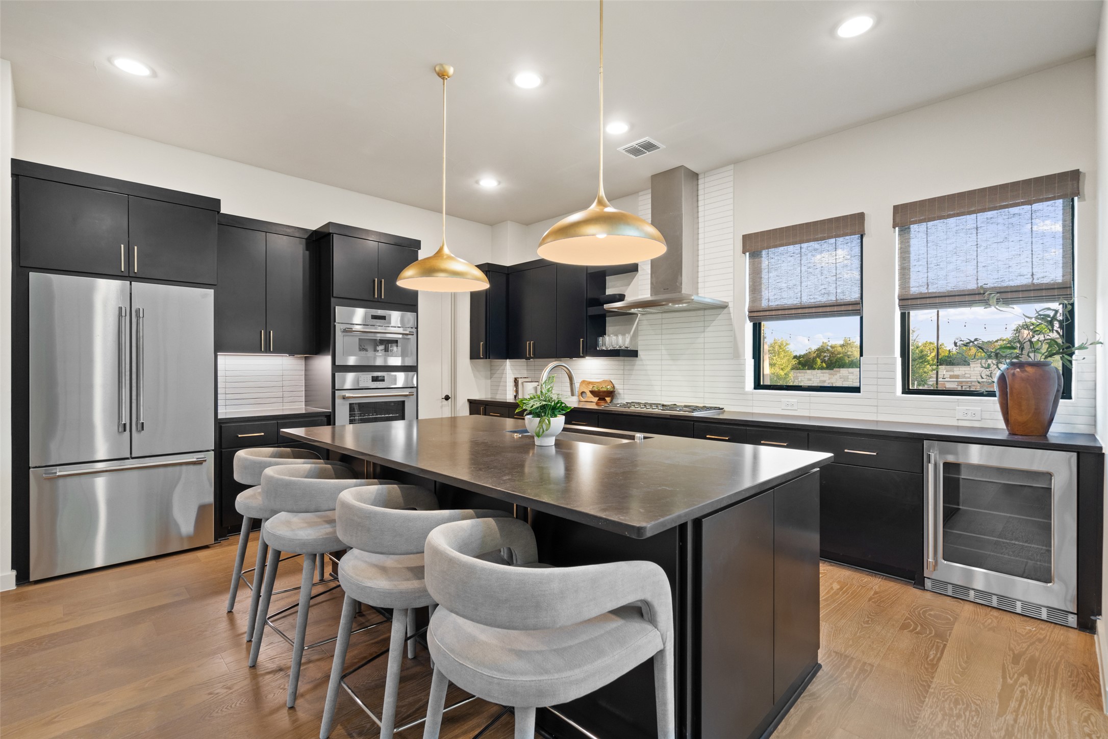 9803 Ribelin Ranch Court, Unit 19 Austin, TX 78750 - Photo 2 of 14 Culinary excellence awaits in this well-appointed kitchen, featuring a central island and a suite of high-end appliances.