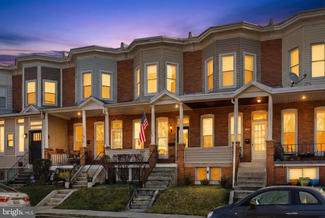 a front view of a residential apartment building with a yard