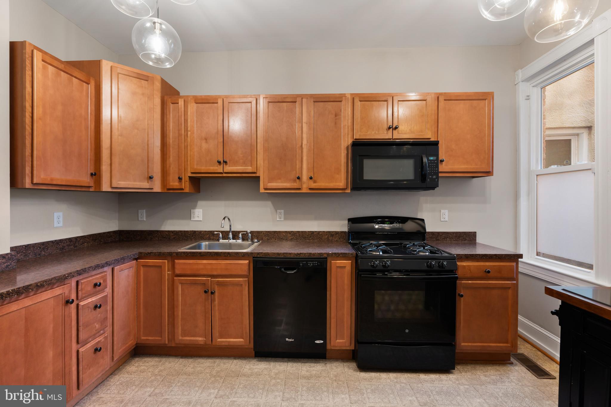 347 Yale Avenue Baltimore, MD 21229 - Photo 16 of 59 a kitchen with stainless steel appliances granite countertop wooden cabinets and a stove top oven