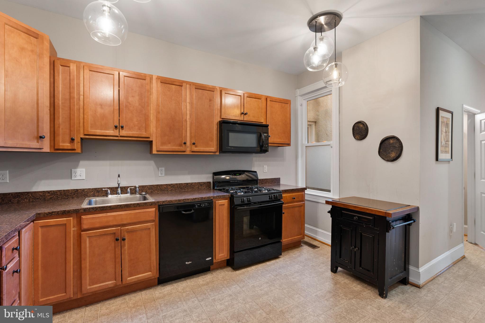 347 Yale Avenue Baltimore, MD 21229 - Photo 17 of 59 a kitchen with stainless steel appliances granite countertop a stove and a sink