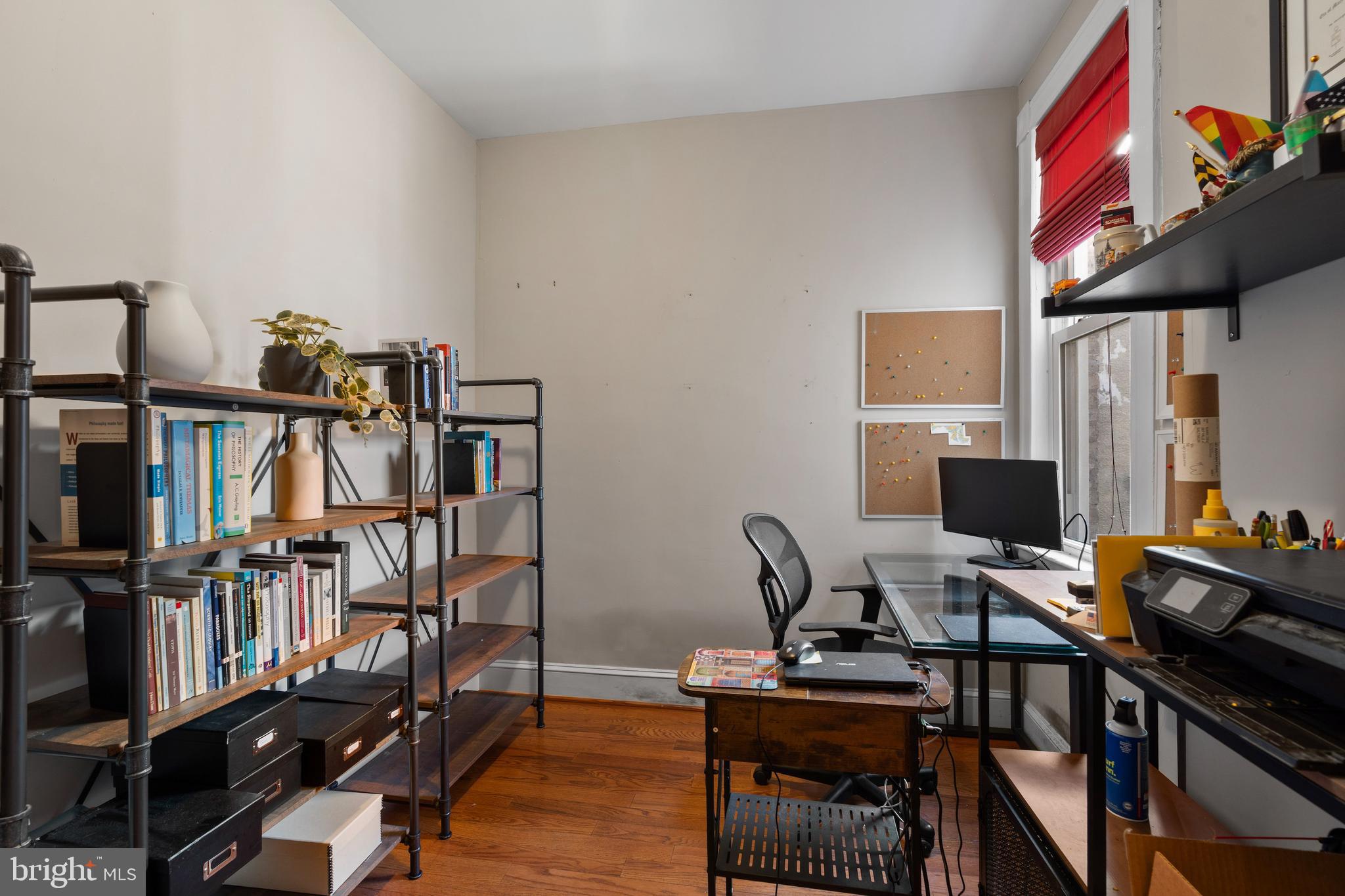 347 Yale Avenue Baltimore, MD 21229 - Photo 23 of 59 a view of a workspace with furniture and wooden floor
