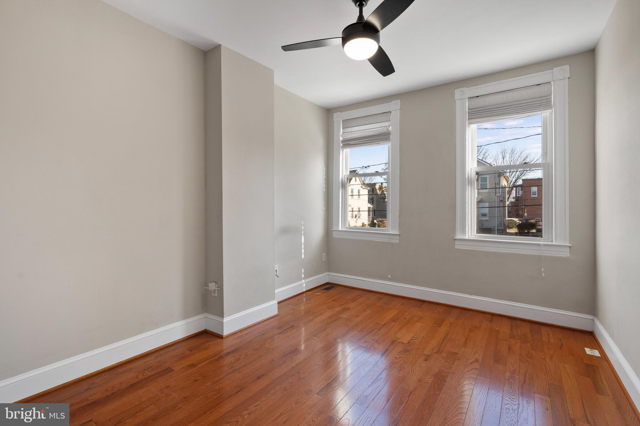 347 Yale Avenue Baltimore, MD 21229 - Photo 25 of 59 a view of an empty room with wooden floor and a window