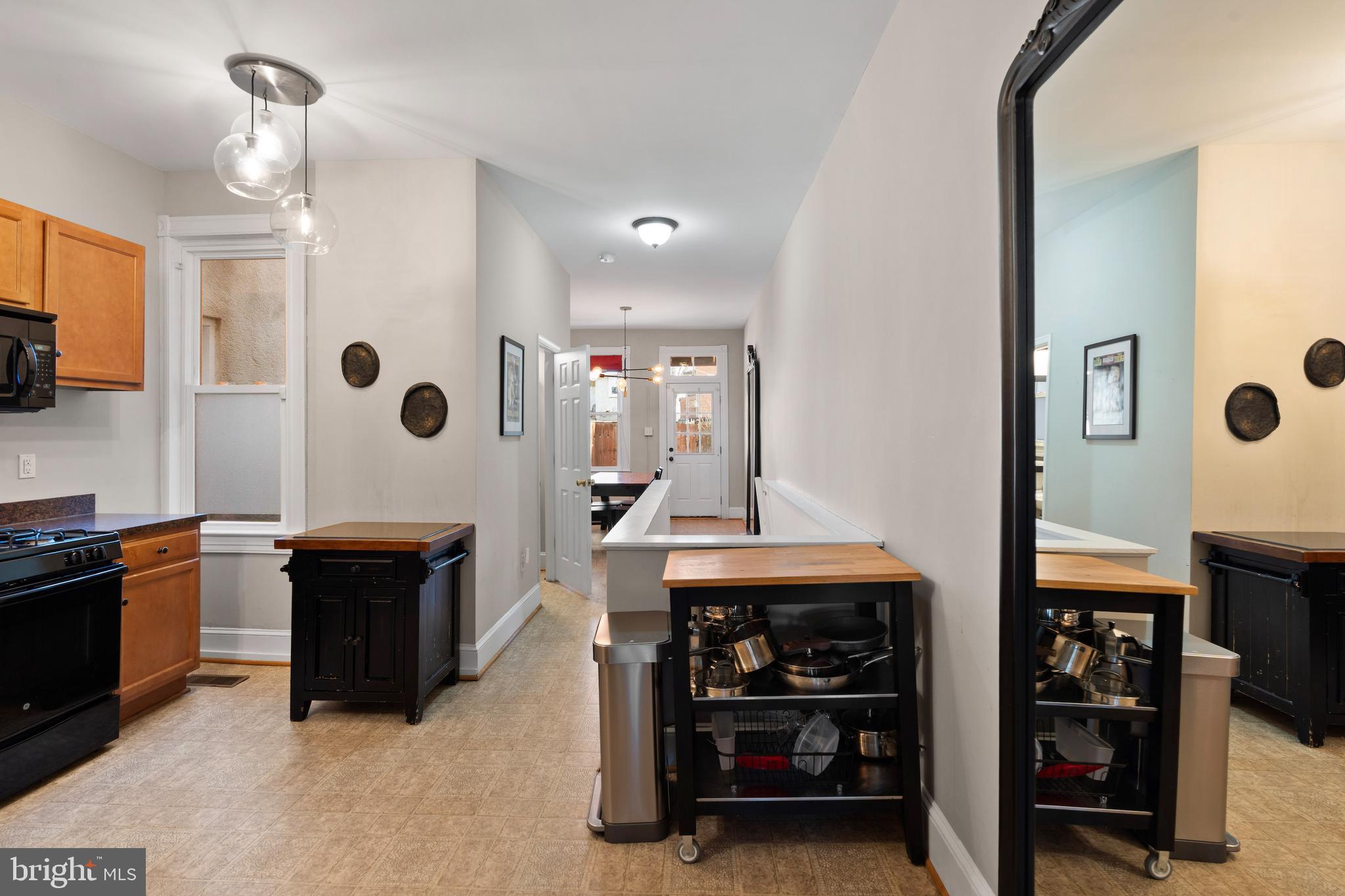 347 Yale Avenue Baltimore, MD 21229 - Photo 29 of 59 a kitchen with stainless steel appliances granite countertop a stove and a refrigerator