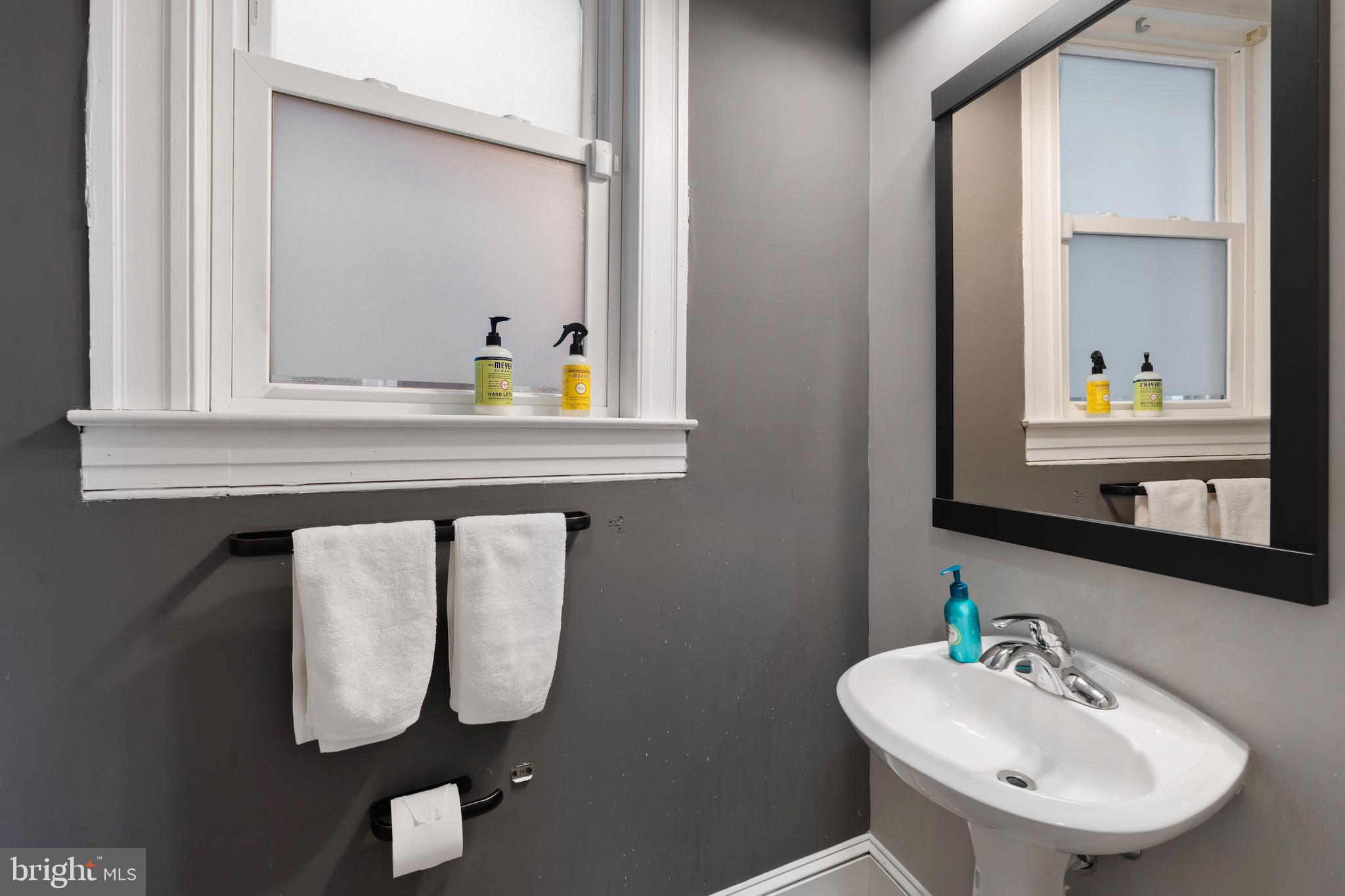 347 Yale Avenue Baltimore, MD 21229 - Photo 30 of 59 a bathroom with a sink mirror and vanity