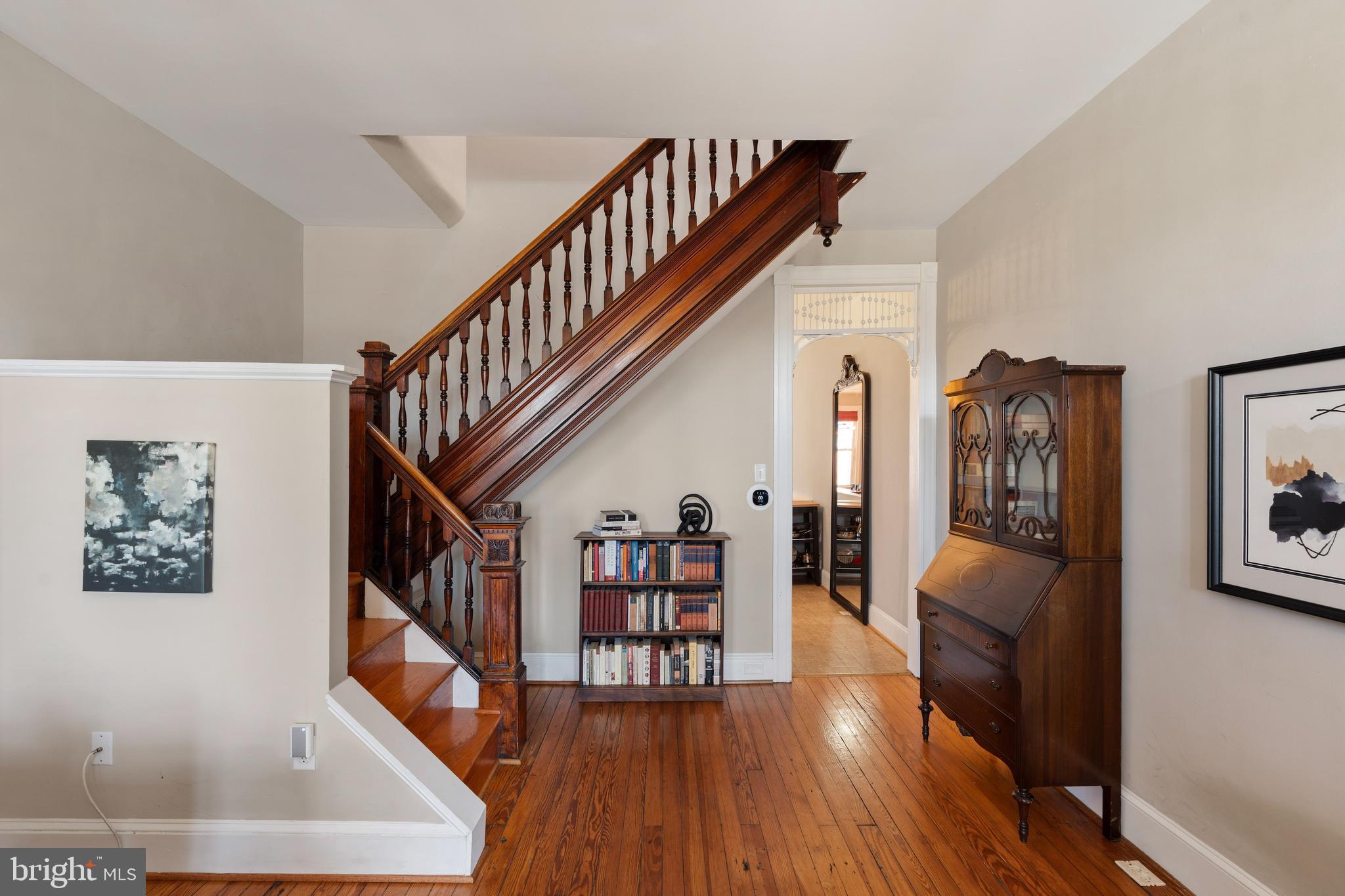 347 Yale Avenue Baltimore, MD 21229 - Photo 4 of 59 a view of a hallway with wooden floor and stairs