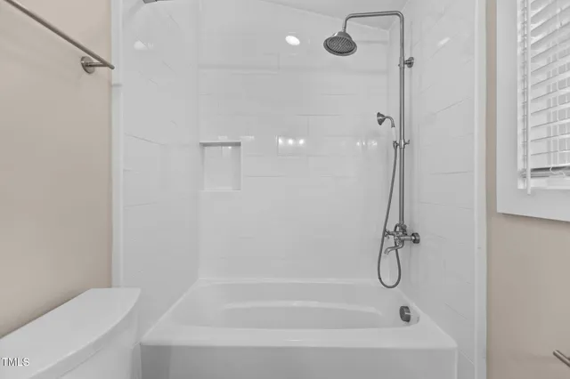 a bathroom with a shower and a shower