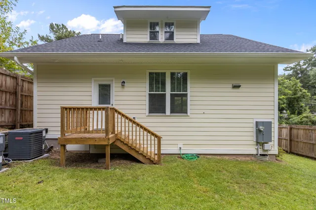 a backyard of a house with yard and deck