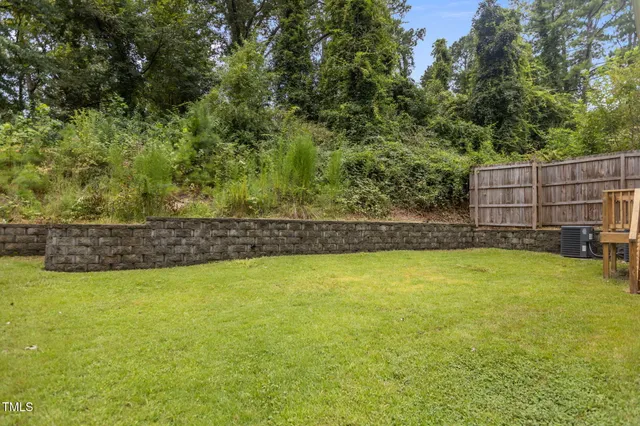 a view of a pool and trees in the background