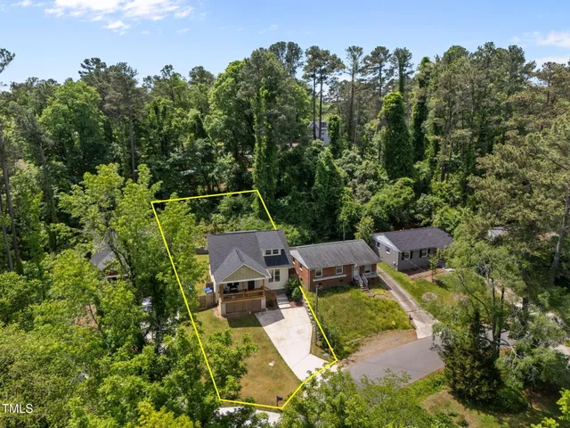 an aerial view of a house with swimming pool and garden view