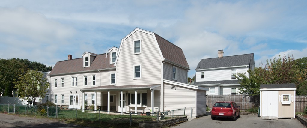 a view of multiple houses with a yard
