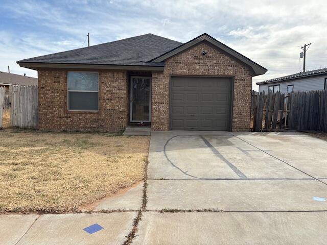 405 45th Street Lubbock, TX 79404 - Photo 2 of 3 a front view of a house with a garage