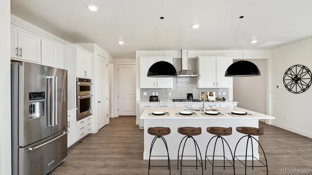 a view of a patio with couches table and chairs under an umbrella