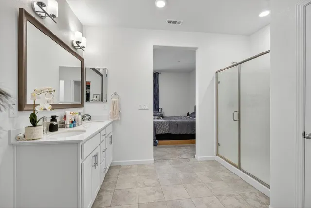 a en suite bathroom with a sink a mirror and a vanity