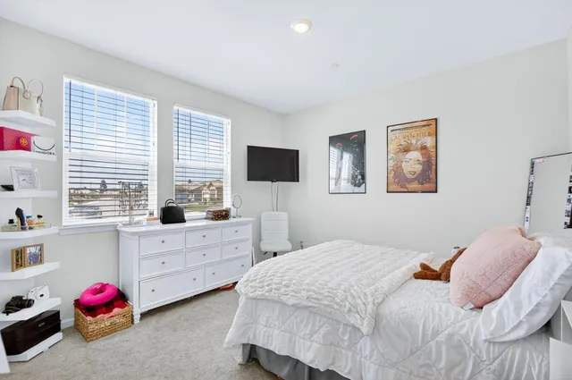 a bedroom with a bed and window