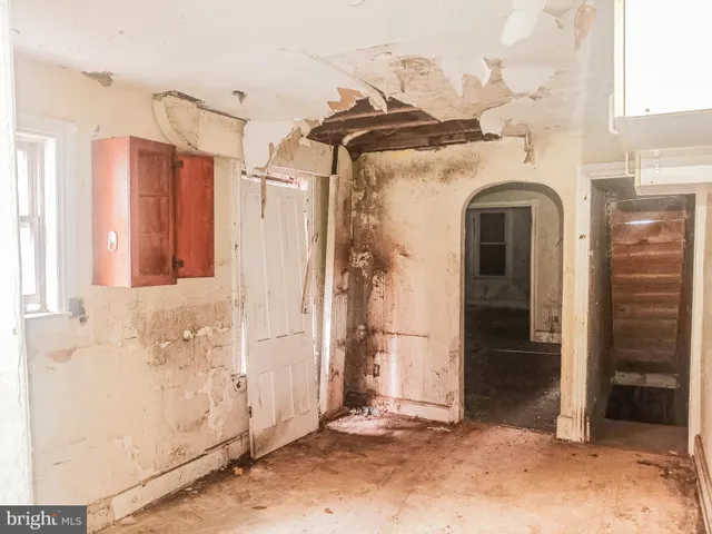 a view of a room with wooden floor and cabinet
