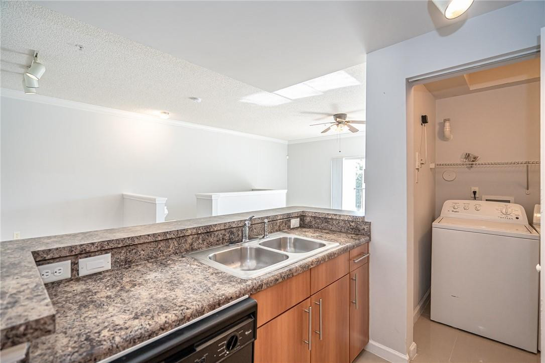 5860 West Sample Road, Unit 304 Coral Springs, FL 33067 - Photo 11 of 22 a view of a sink and washer dryer