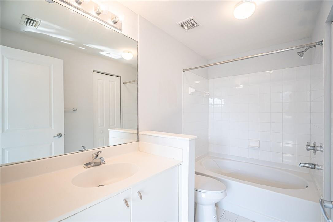 5860 West Sample Road, Unit 304 Coral Springs, FL 33067 - Photo 13 of 22 a bathroom with a sink mirror toilet and bathtub
