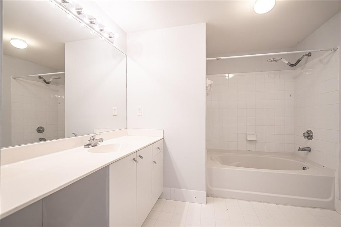 5860 West Sample Road, Unit 304 Coral Springs, FL 33067 - Photo 14 of 22 a bathroom with a bathtub and a sink