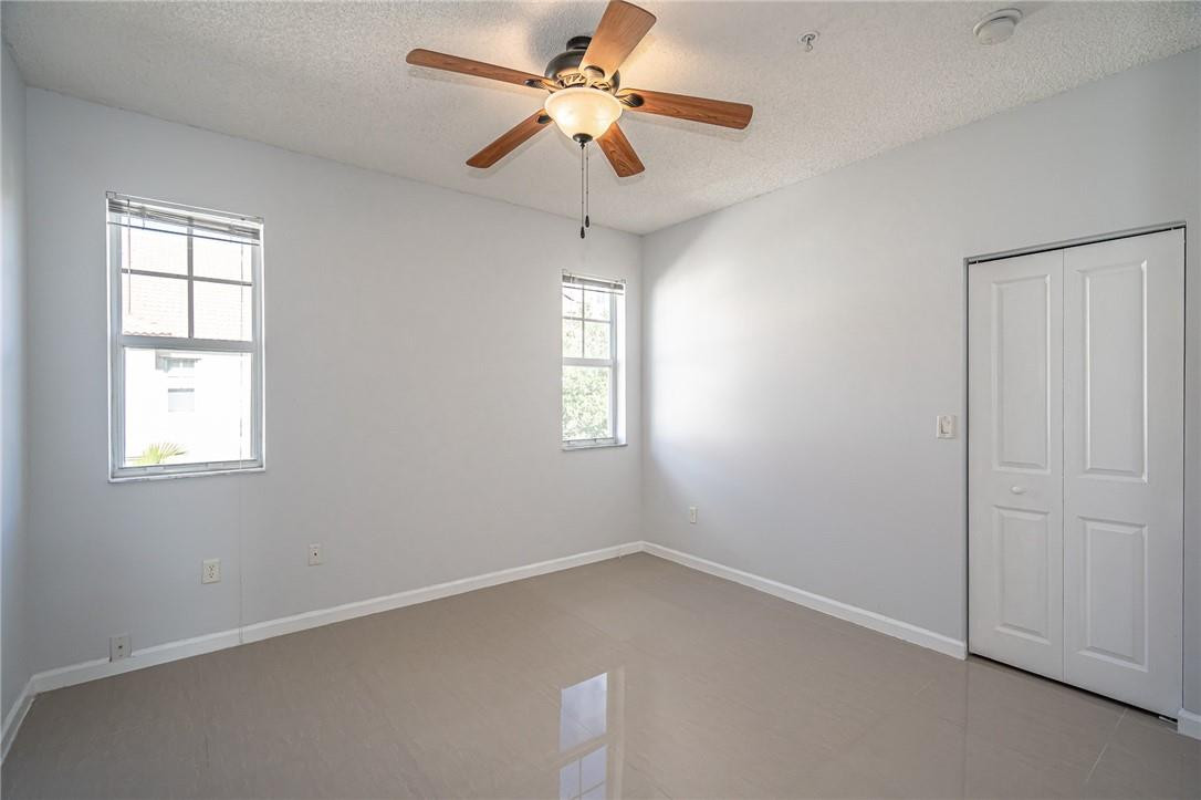 5860 West Sample Road, Unit 304 Coral Springs, FL 33067 - Photo 18 of 22 an empty room with a window and a fan