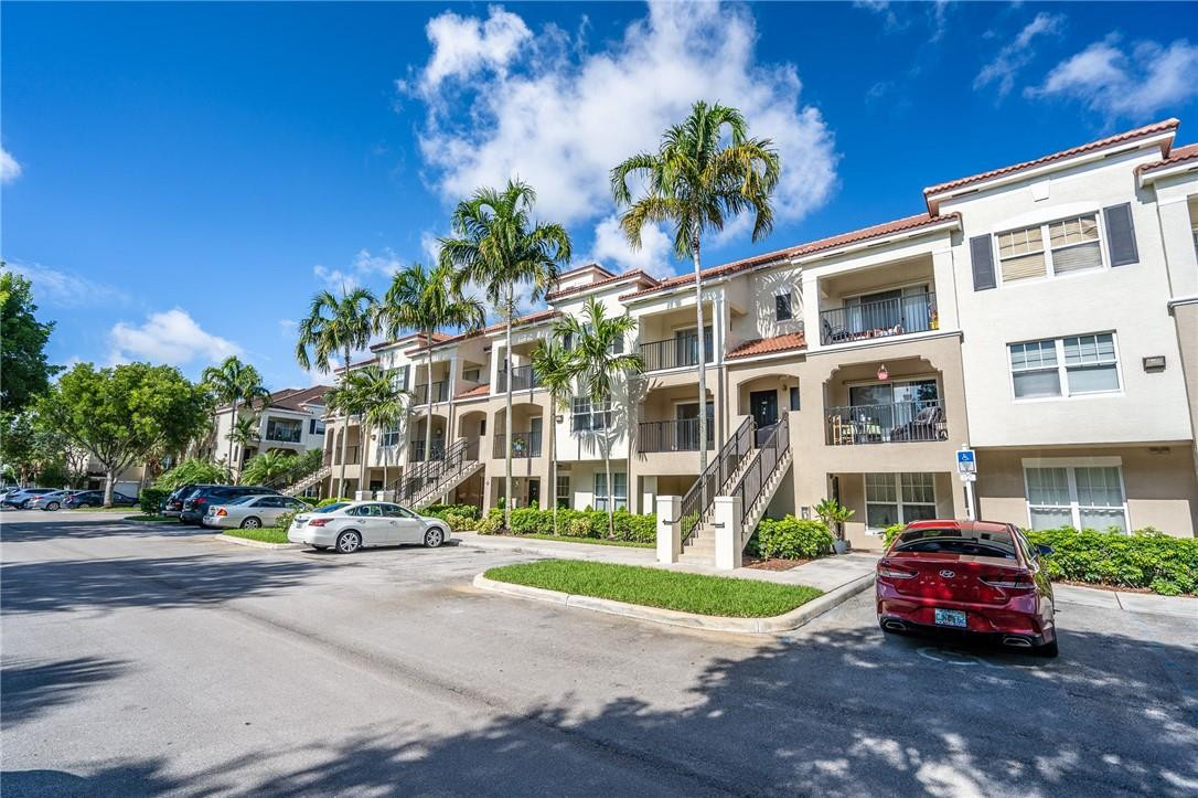 5860 West Sample Road, Unit 304 Coral Springs, FL 33067 - Photo 20 of 22 a parked cars parked in front of a building