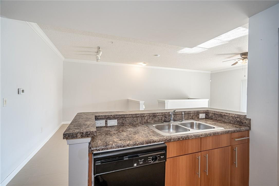 5860 West Sample Road, Unit 304 Coral Springs, FL 33067 - Photo 6 of 22 a view of a kitchen sink appliances and cabinets
