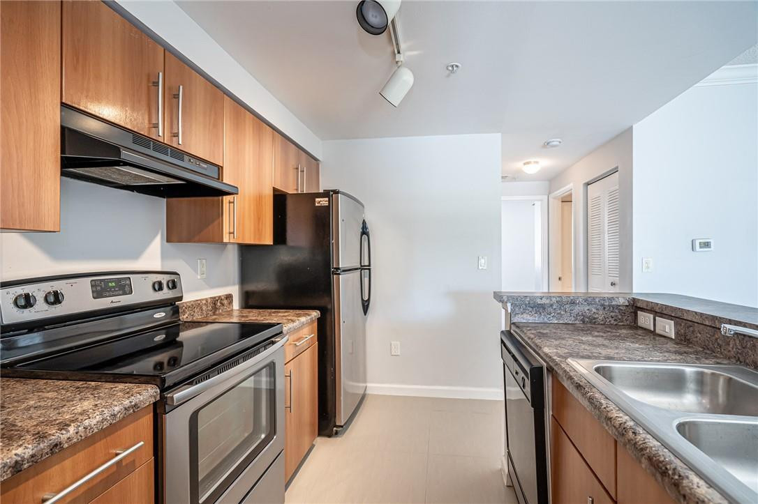 5860 West Sample Road, Unit 304 Coral Springs, FL 33067 - Photo 10 of 22 a kitchen with granite countertop a sink stove and refrigerator