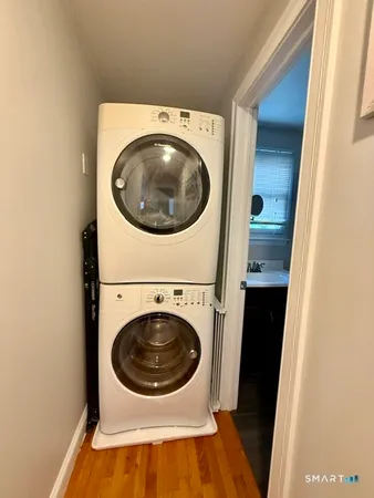 a view of a balcony with wooden floor and fence