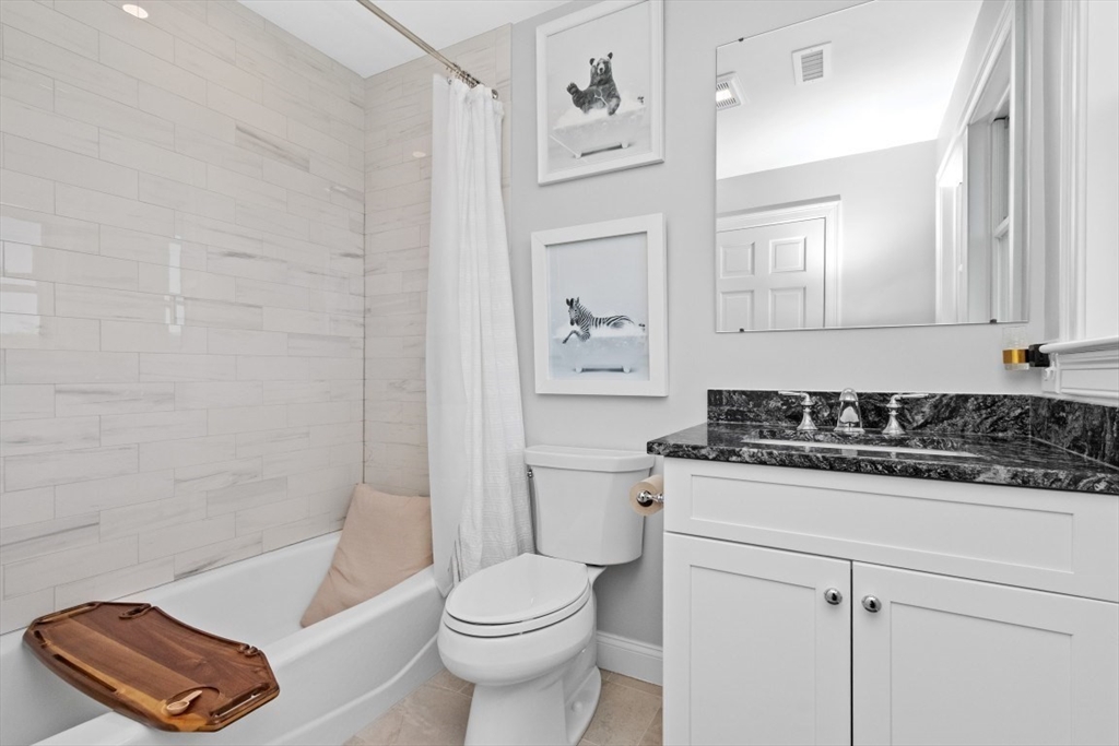 20 College Farm Road Waltham, MA 02451 - Photo 18 of 32 a bathroom with a sink a toilet and a bathtub
