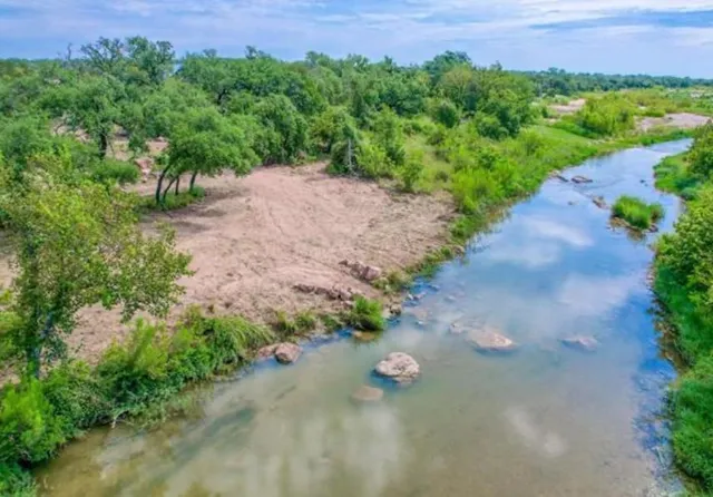 a view of a lake with houses in the back