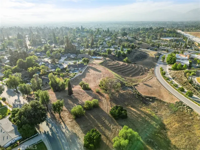 an aerial view of residential houses with city view