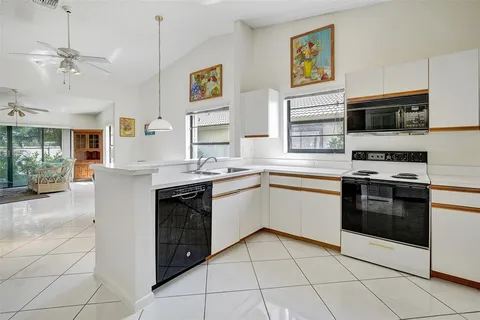 a kitchen with a stove top oven sink and cabinets