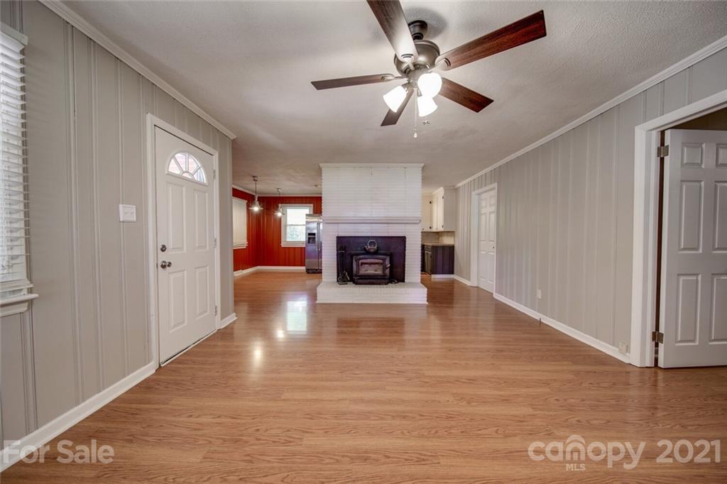 3802 Austin Road Monroe, NC 28112 - Photo 12 of 43 a view of an empty room with wooden floor fireplace and a window