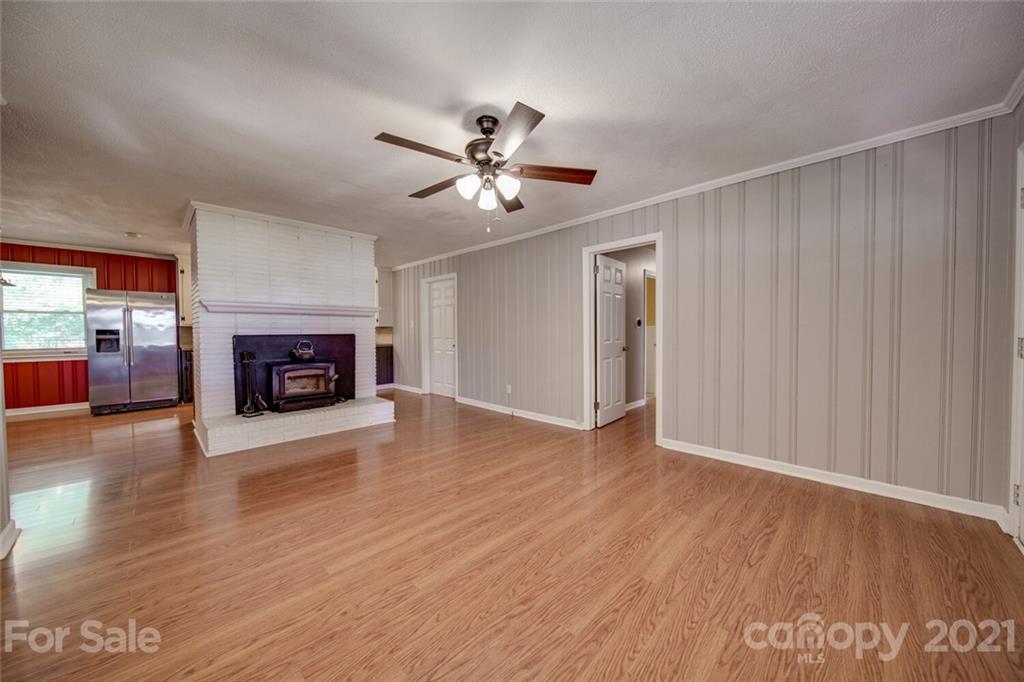 3802 Austin Road Monroe, NC 28112 - Photo 13 of 43 a view of empty room with wooden floor and fireplace
