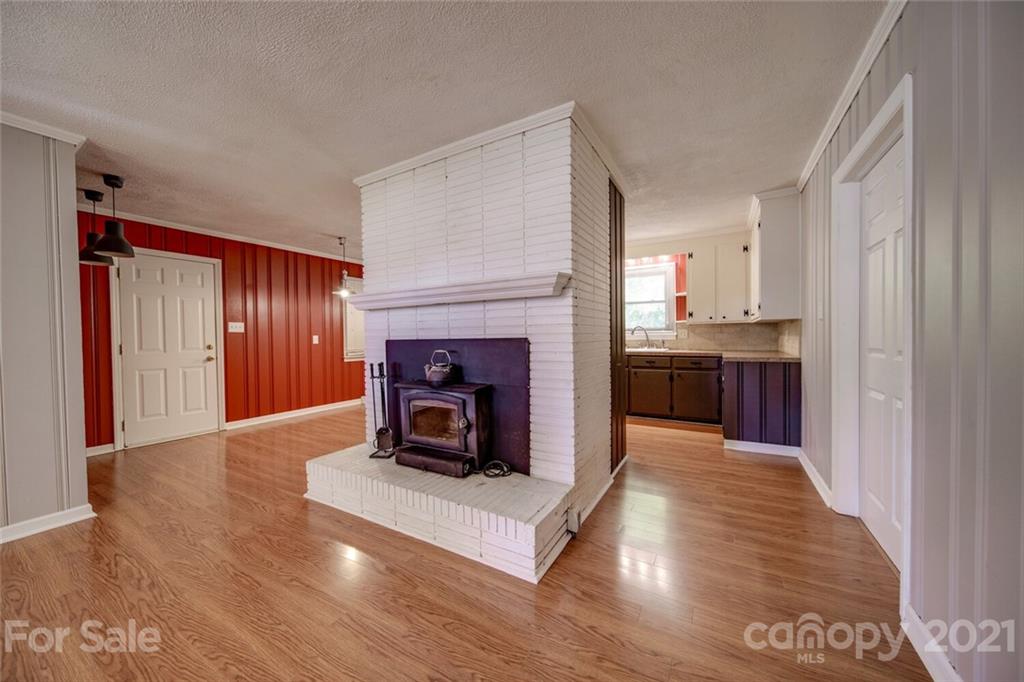 3802 Austin Road Monroe, NC 28112 - Photo 16 of 43 a living room with stainless steel appliances furniture a fireplace and wooden floor