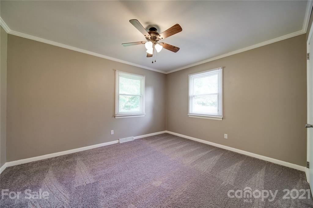3802 Austin Road Monroe, NC 28112 - Photo 29 of 43 an empty room with ceiling fan and windows