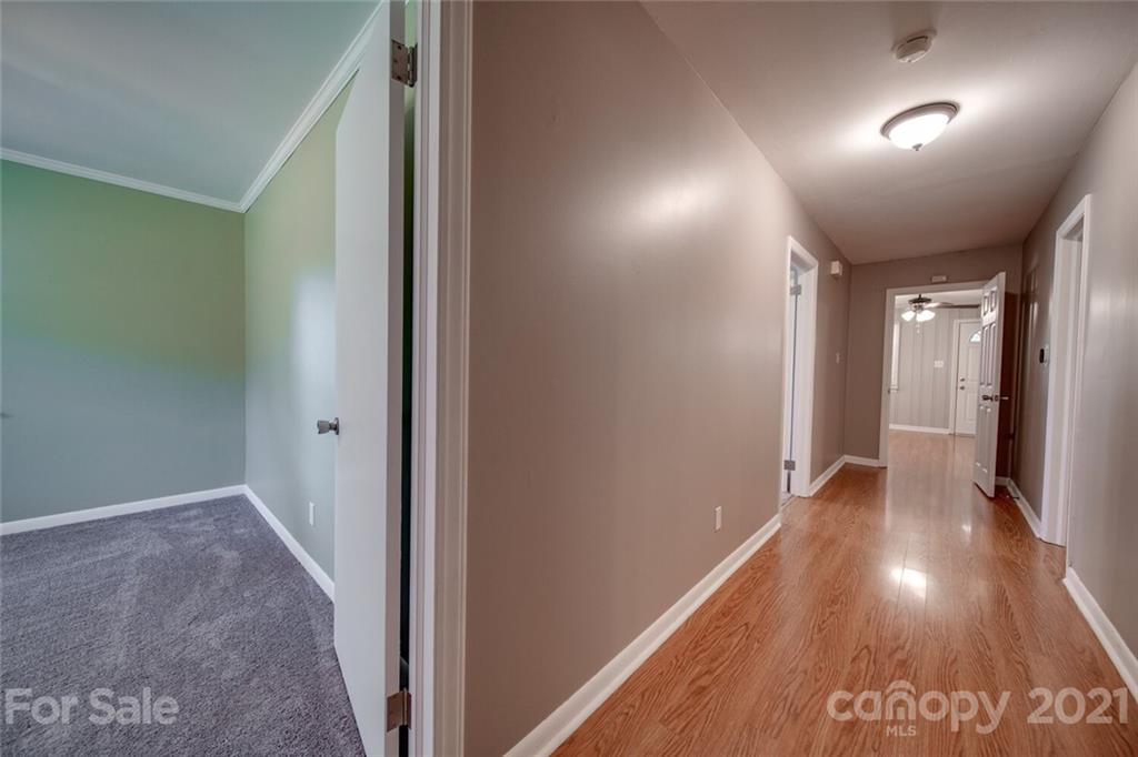 3802 Austin Road Monroe, NC 28112 - Photo 41 of 43 a view of hallway with stairs and wooden floor