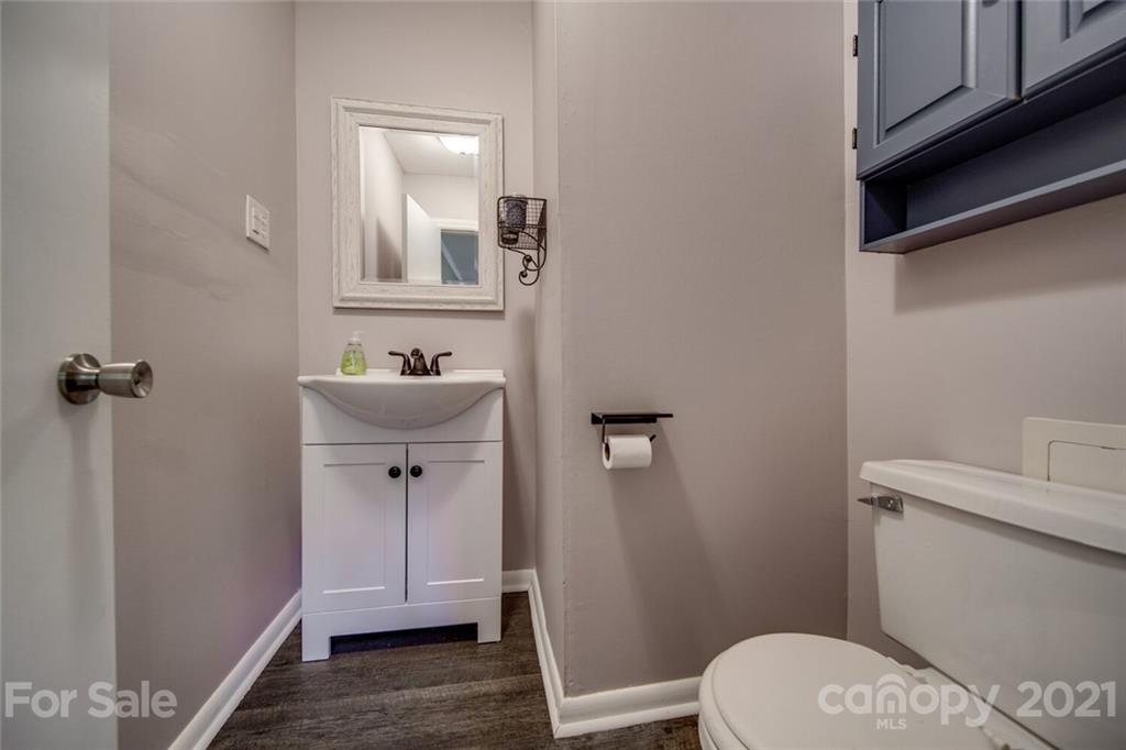 3802 Austin Road Monroe, NC 28112 - Photo 42 of 43 a bathroom with a sink a toilet a mirror and shower