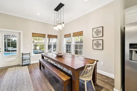 a kitchen with sink a stove and chairs