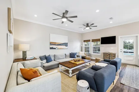 a living room with furniture and a view of kitchen