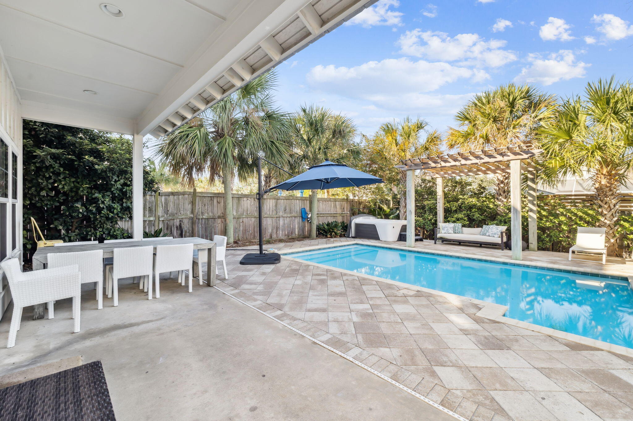 20 Sundance Court Miramar Beach, FL 32550 - Photo 25 of 53 a view of a swimming pool with a table and chairs under an umbrella