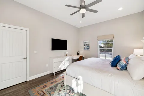 a bedroom with a bed and a chandelier