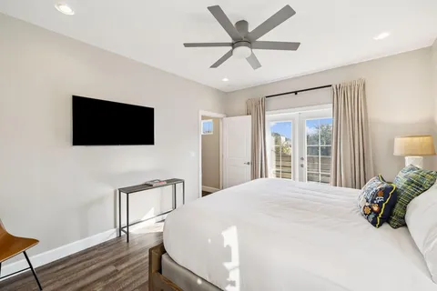 a bedroom with a bed and wooden floor