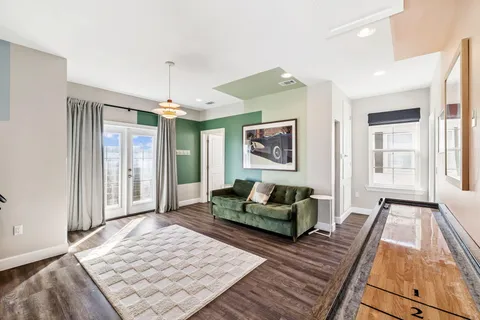 a view of a balcony with floor to ceiling windows with wooden floor