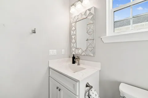a view of a bedroom with furniture and wooden floor